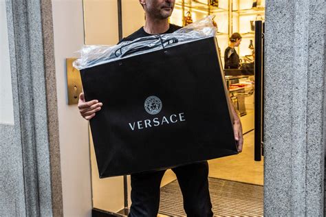 michael kors buys out versace|does michael kors own versace.